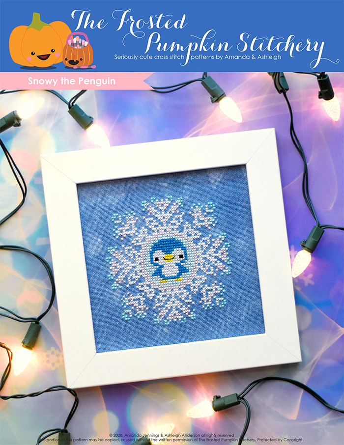 Image of Snowy the Penguin counted cross stitch pattern featuring a sparkly blue penguin in the center of a snowflake and framed in a simple white frame.