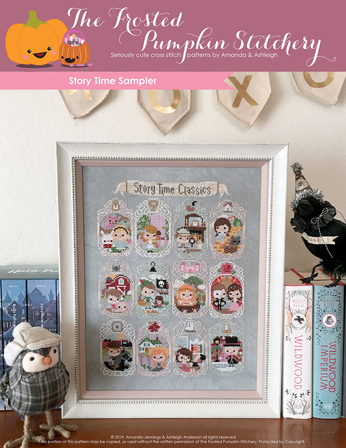 Storytime Sampler counted cross stitch pattern. Twelve characters from stories such as Alice in Wonderland, Phantom of the Opera, Anne of Green Gables and more. It's in a white frame on a bookshelf.