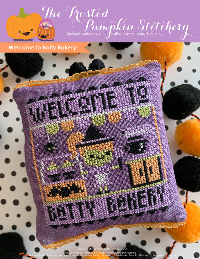 Welcome to Batty Bakery Halloween counted cross stitch pattern. A green skinned purple haired witch stands in front of a mixer holding a spatula.